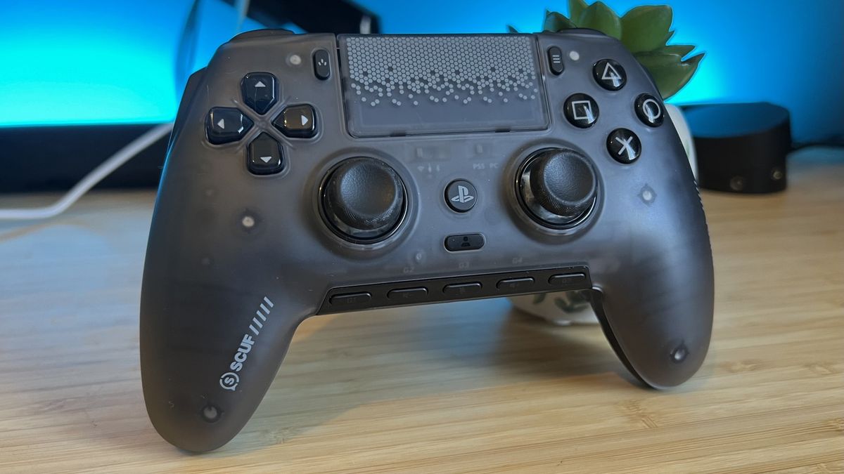 Scuf Omega PS5 controller on a wooden desk with blue backlighting