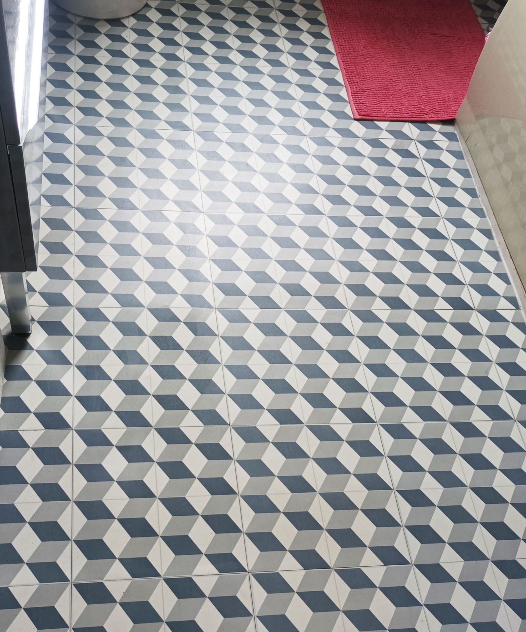 geometric patterned peel and stick tiles on bathroom floor