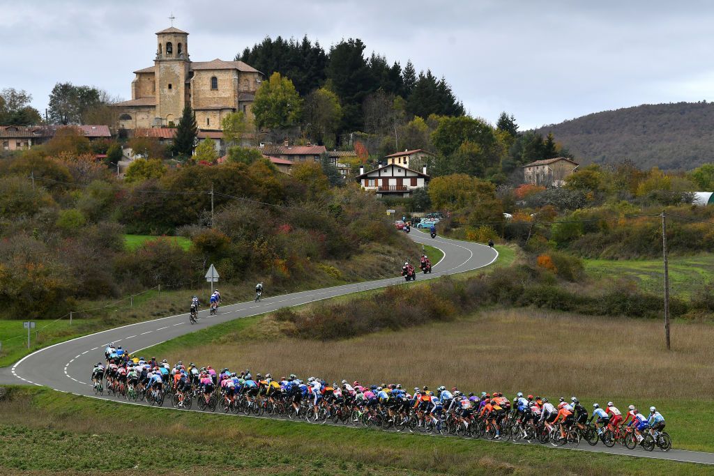 VILLANUEVA DE VALDEGOVIA SPAIN OCTOBER 27 Richard Carapaz of Ecuador and Team INEOS Grenadiers Red Leader Jersey Enric Mas Nicolau of Spain and Movistar Team White Best Young Rider Jersey Tim Wellens of Belgium and Team Lotto Soudal Polka Dot Mountain Jersey Primoz Roglic of Slovenia and Team Jumbo Visma Green Points Jersey Manurga Village Landscape Peloton Church during the 75th Tour of Spain 2020 Stage 7 a 1597km from VitoriaGasteiz to Villanueva de Valdegovia lavuelta LaVuelta20 La Vuelta on October 27 2020 in Villanueva de Valdegovia Spain Photo by Justin SetterfieldGetty Images