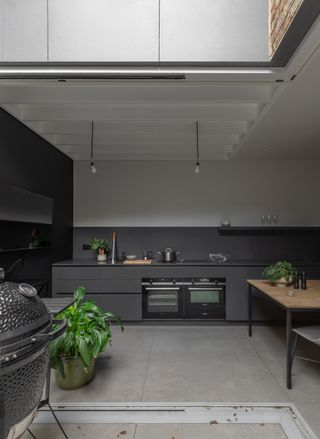double height kitchen space with grey cabinets in air house in London