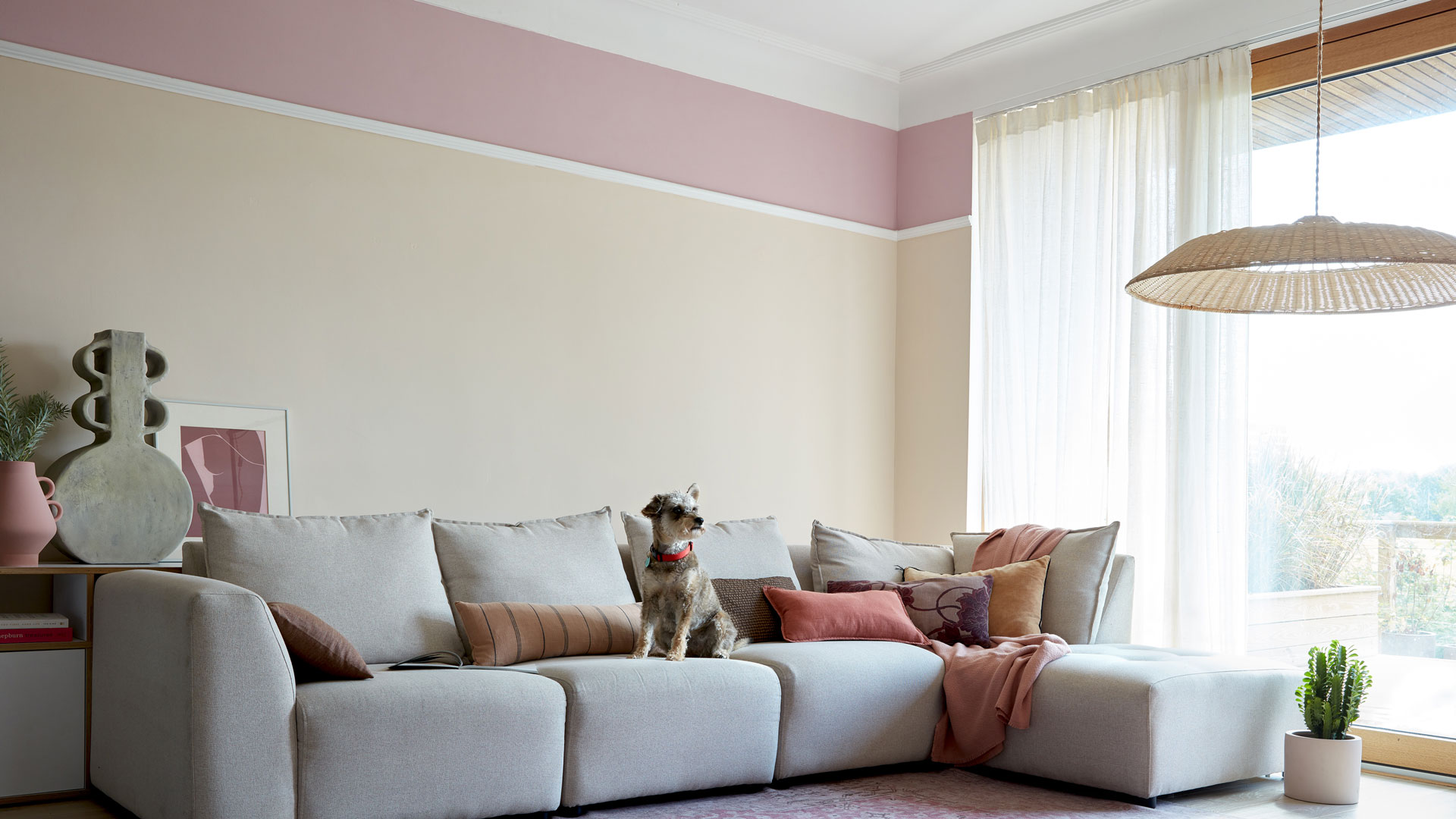 two tone pink living room with large gret modular sofa