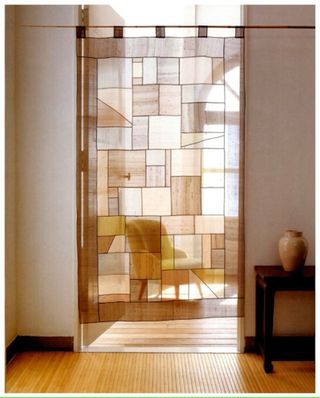 Patchwork, Pojagi wall hanging in a minimalist door way with a wooden side table and vase next to it