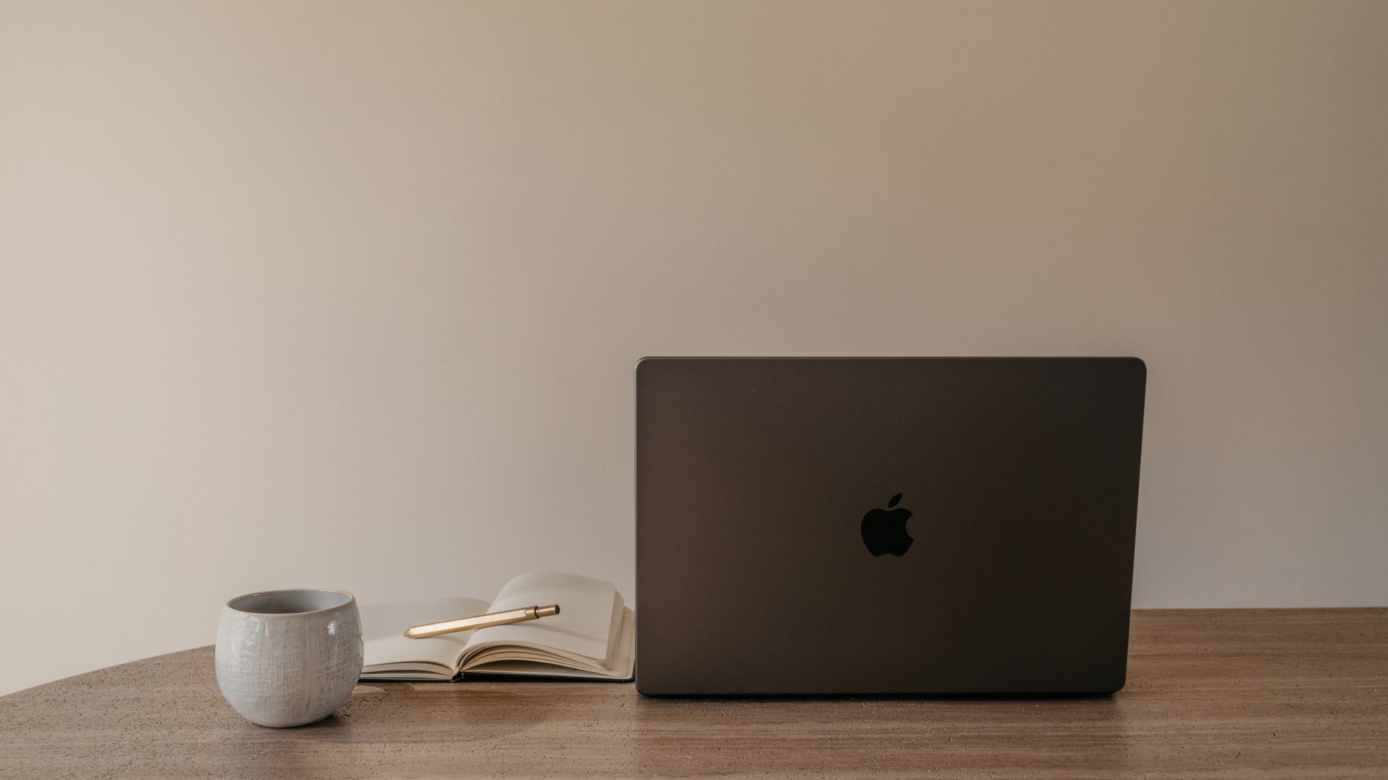 A woman stretching: a laptop, notepad and coffee