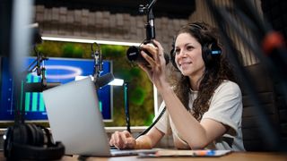 Woman records a podcast wearing headphones