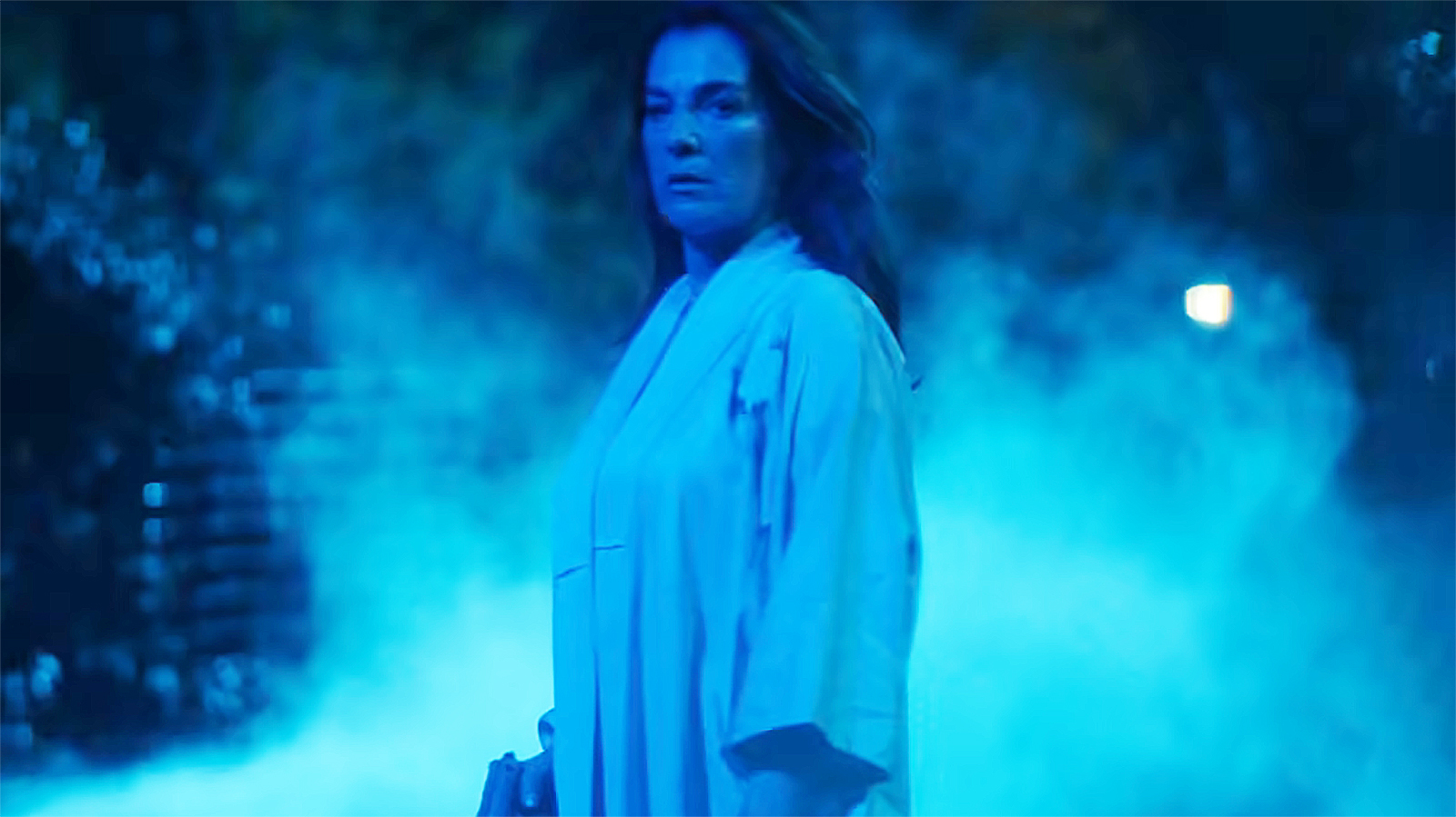 Vanessa Fisk holding a pistol and bathed in blue light at night in Daredevil: Born Again season 2