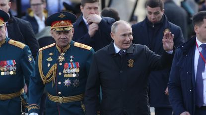 Vladimir Putin and Defence Minister Sergei Shoigu attend the Victory Day parade in Red Square