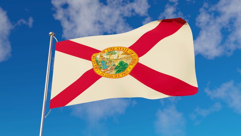 Florida flag flying against a bright blue sky