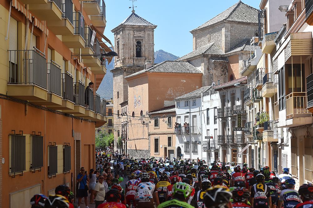 The peloton make their way through town