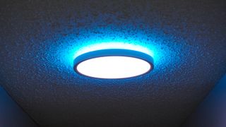 One of Govee's smart ceiling lights installed in a hallway with the main light showing white and the back light set to blue