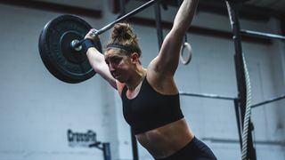 CrossFit athlete Lucy Campbell lifting a barbell overhead