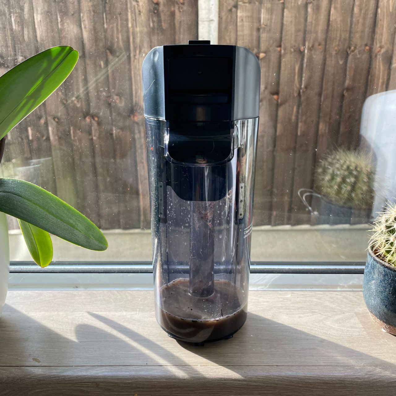Tineco Smart Mop dirty water tank sitting on a window sill