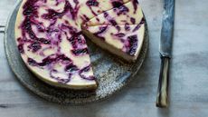 Blackberry ripple cheesecake on a grey mottled plate