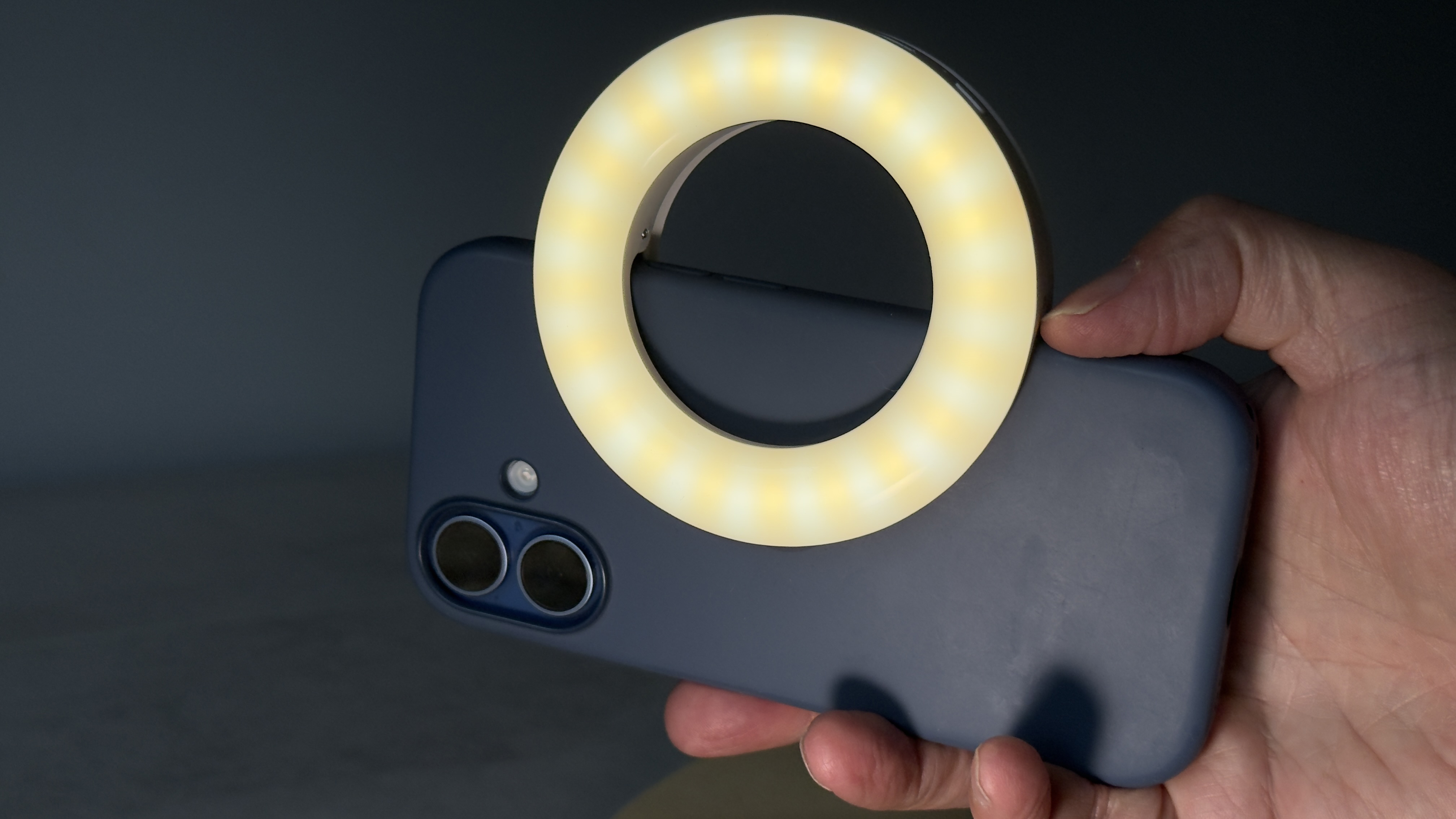 Shot of the LED clipped to an iPhone so that it illuminates in the same direction as the rear-facing cameras.