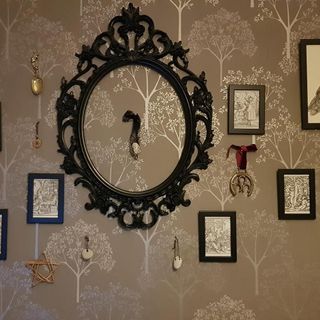 room with wall paper and frames on wall