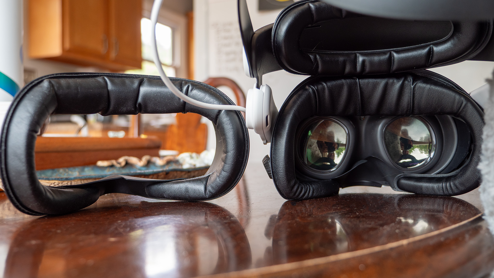 An AMVR face pad with glasses adjustment wheels on a Meta Quest 3, next to a Kiwi Quest 3S face pad by itself