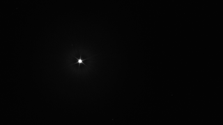 A bright star against a black background