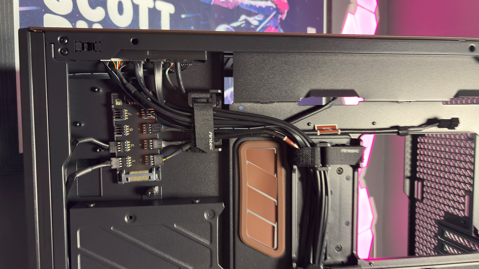 The Antec Flux Pro Noctua Edition on a desk with various parts disassembled.