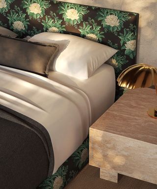 lotus flower patterned upholstery bed frame with white bed linen and a stone nightstand with a brass leaf-inspired lamp