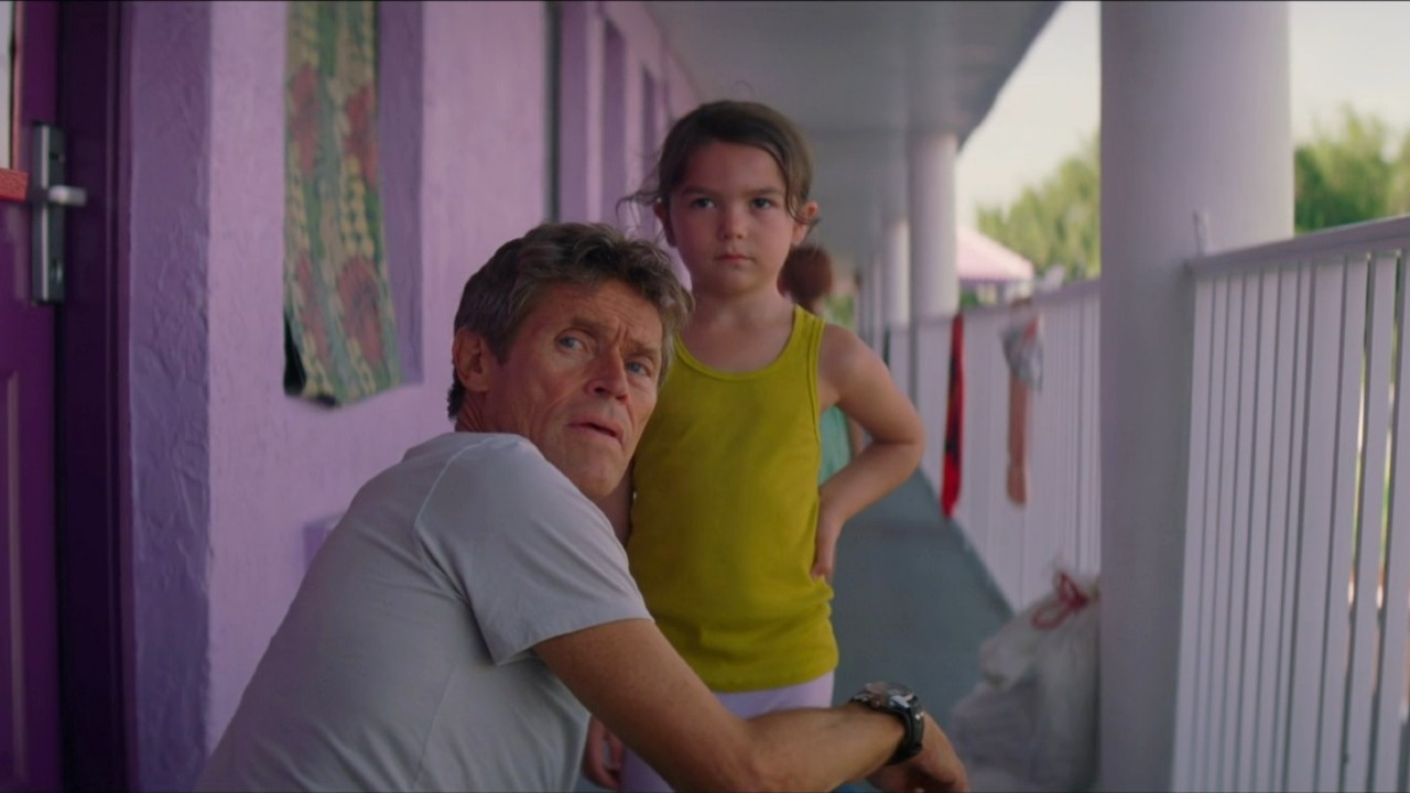 Willem Dafoe and Brooklyn Prince looking in The Florida Project.
