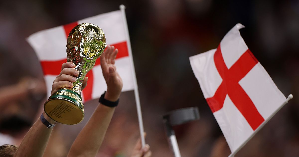 A detailed view of a replica FIFA World Cup trophy held by England fans after the team&#039;s victory during the FIFA World Cup Qatar 2022 Round of 16 match between England and Senegal at Al Bayt Stadium on December 04, 2022 in Al Khor, Qatar.