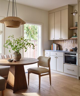 eat-in kitchen with cream cabinetry and round table