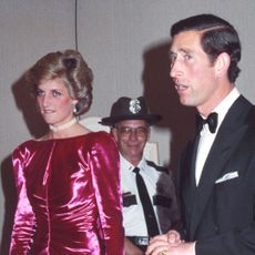Princess Diana wears a cerise pink dress and diamonds, and King Charles wears a tuxedo