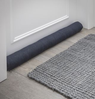 how to make an old home more energy efficient: contemporary dark blue draught excluder from garden trading