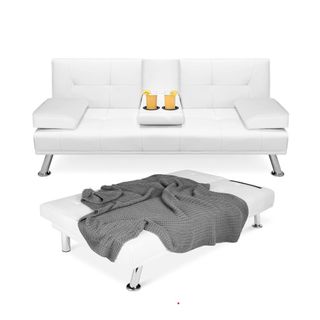 A white couch with cups in it, next to a white footstool with a gray throw