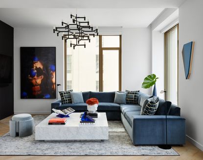 a modern apartment living room with a blue sofa