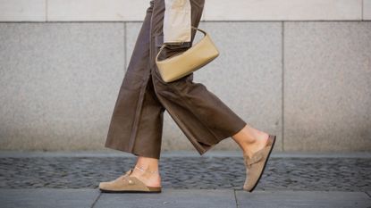 Jacqueline Zelwis is seen wearing ONWEEKENDS Cropped button shirt, brown Gestuz leather pants Oysho shoes, House of Dagmar sunglasses, Olito bag on May 22, 2022 in Berlin, Germany
