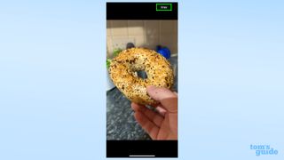 A screenshot showing a zoomed-in image of a bagel with a Crop button in the corner in iOS 17