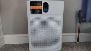 Morento Air Purifier HY4866 next go a gray wall and radiator