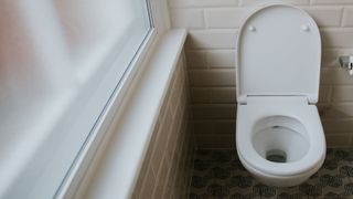 picture of white toilet in tiled bathroom