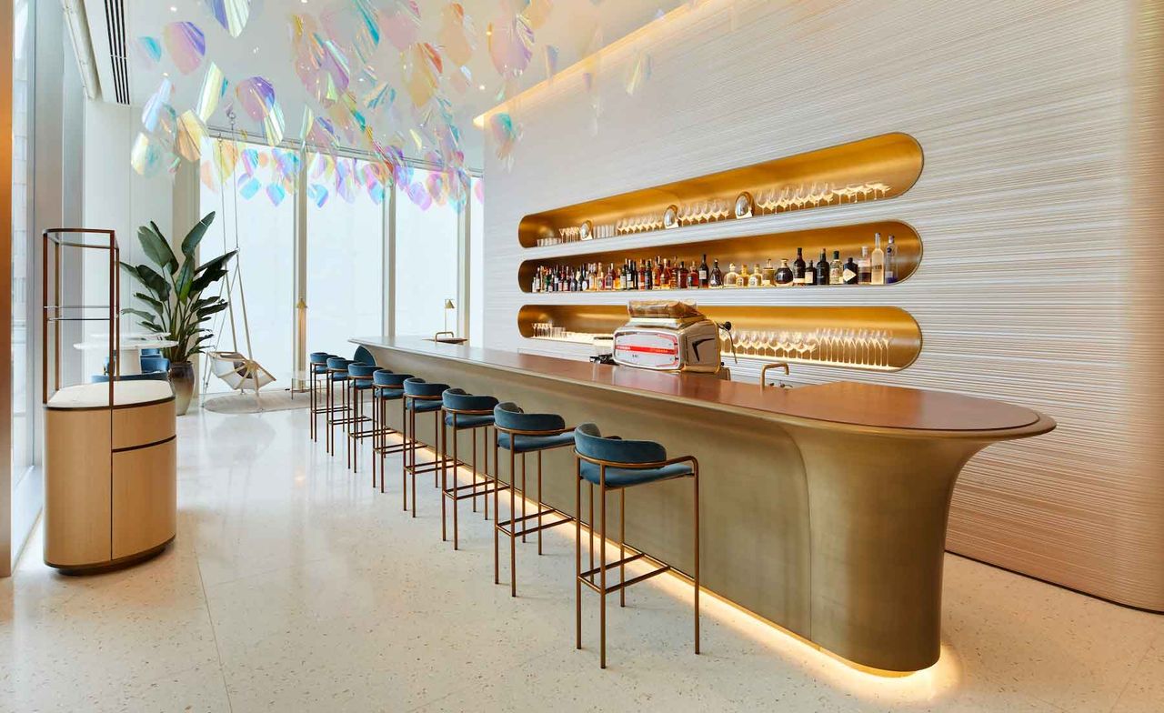 Bar with velvet stools &amp; spirit shelves