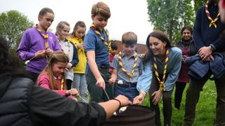 Princess of Wales, Prince George, Princess Charlotte and Prince Louis toast marshmallows as they take part in the Big Help Out