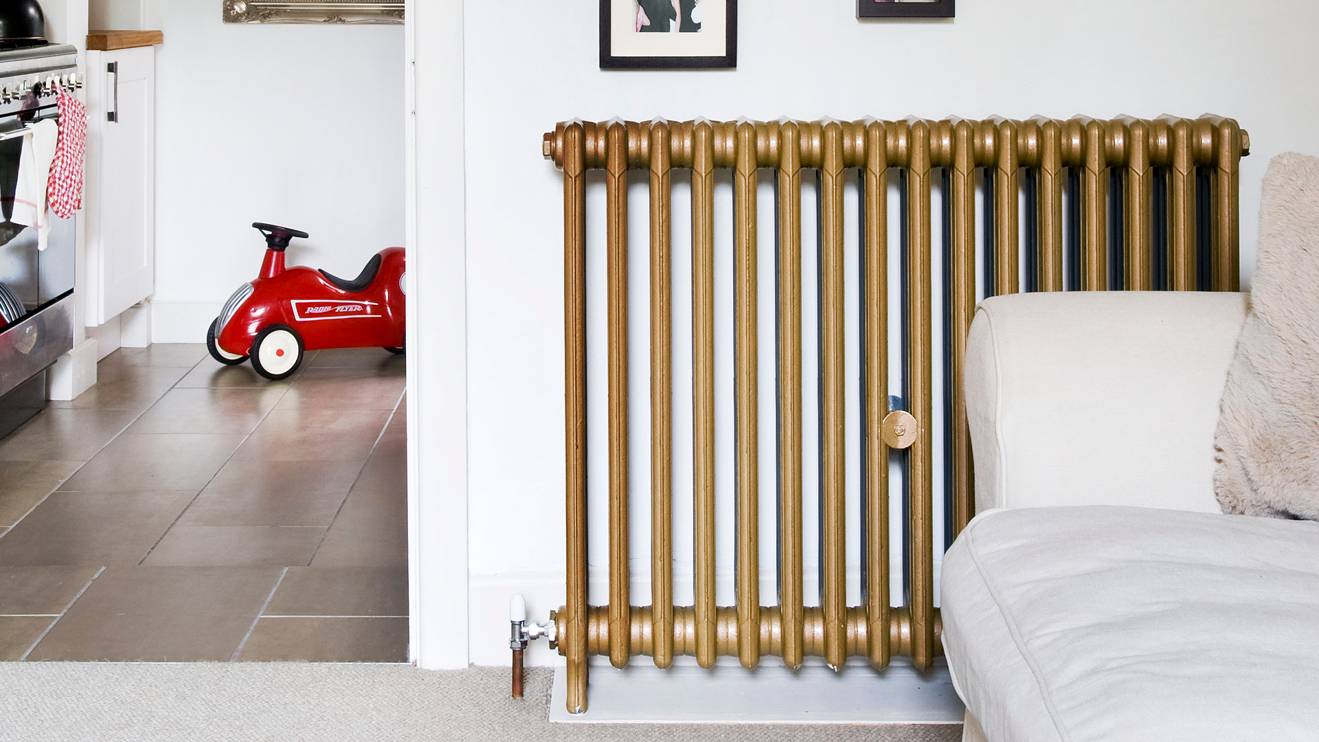 neutral living room with a traditional cast iron radiator in gold brass