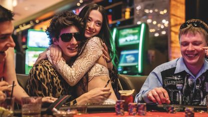 Anora sitting on Ivan's lap in a casino in her self-titled film, one of the best new Hulu movies in March 2025