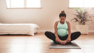 a photo of a pregnant woman doing yoga