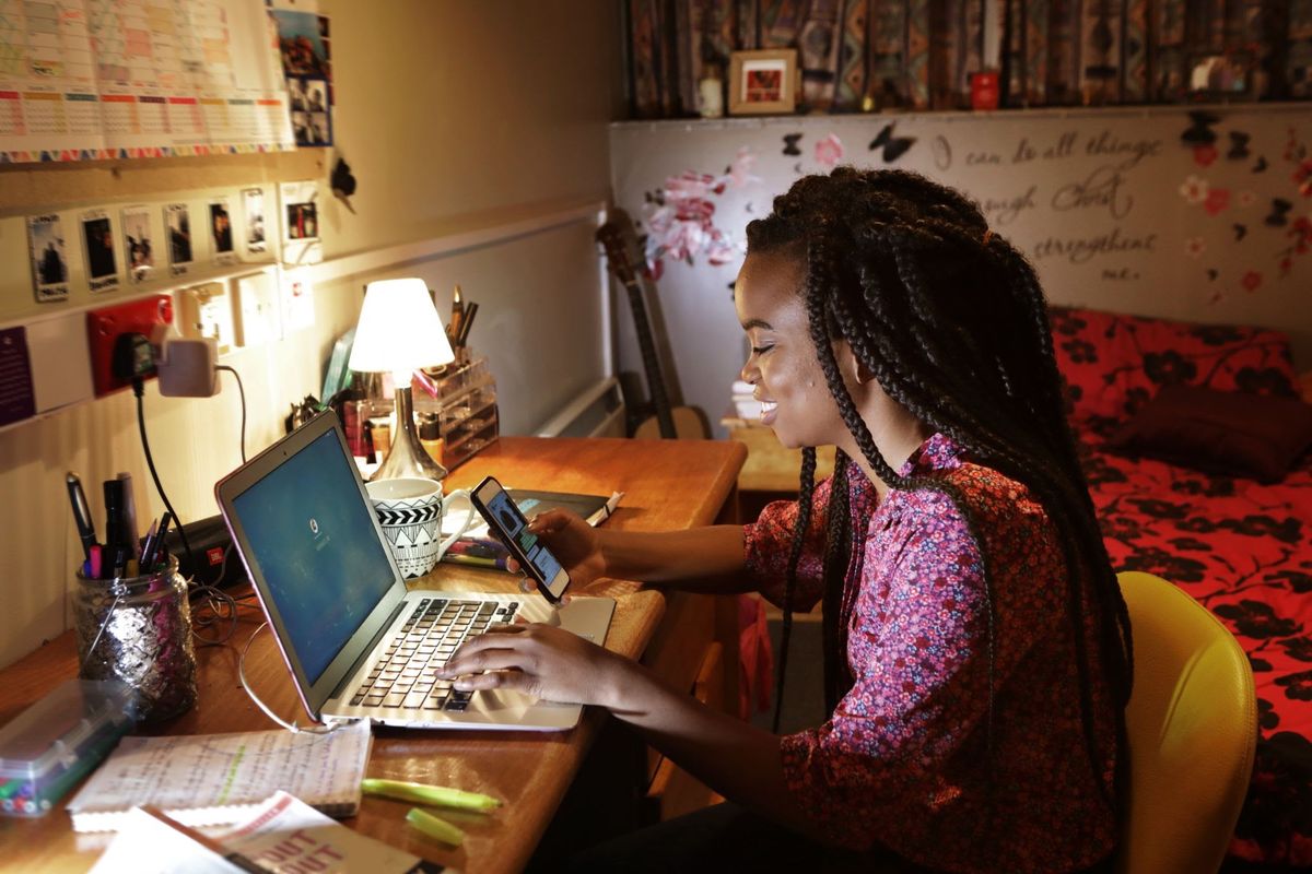 Student working on laptop in dorm room