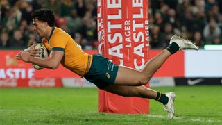 Australia centre Joseph Aukuso-Suaalii dives to score a try in his side's first Rugby Championship 2025 match against South Africa.