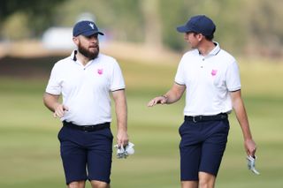 Tyrrell Hatton and Tom McKibbin walk down the fairway