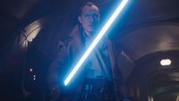 Star Wars Skeleton Crew; a person wielding a vibrant blue lightsaber stands in a dark, tunnel-like setting