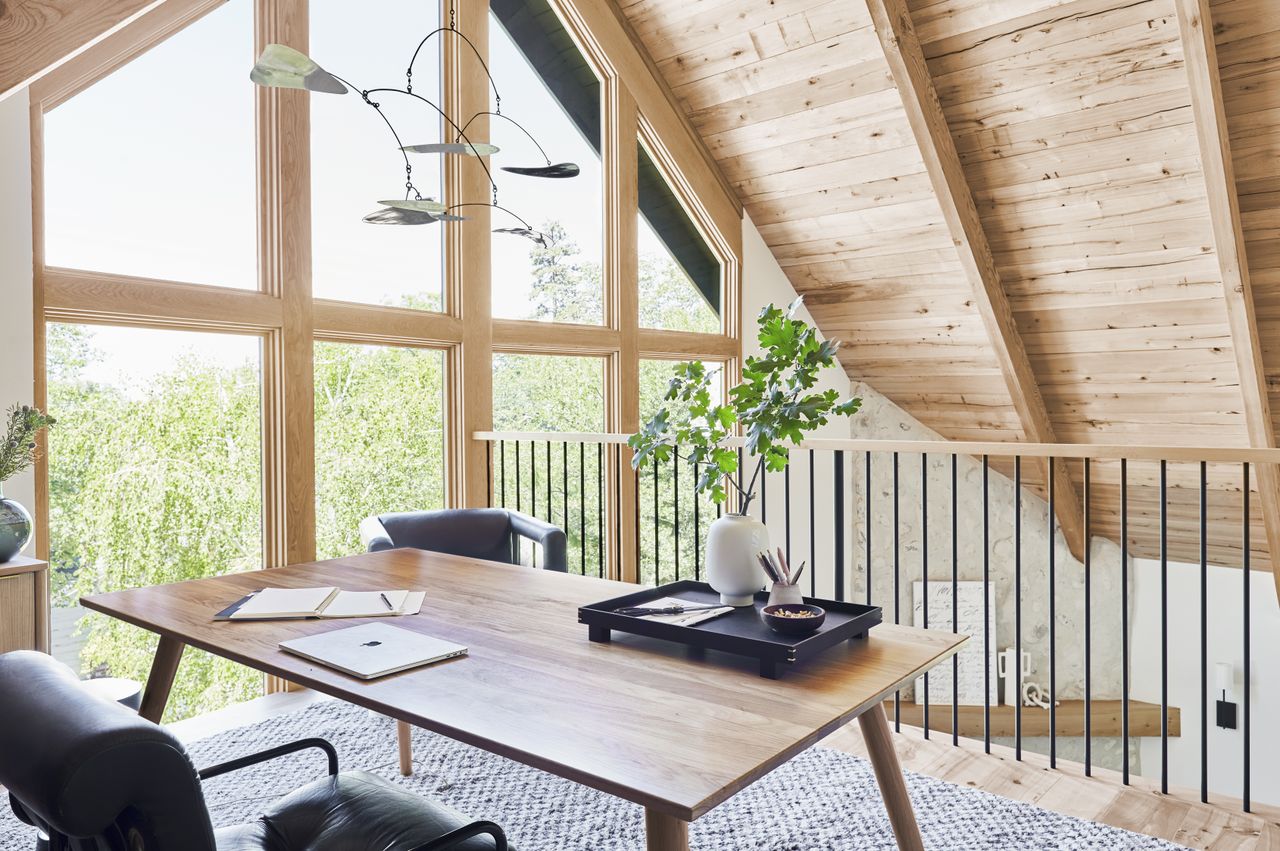 A wooden desk and a leather chair