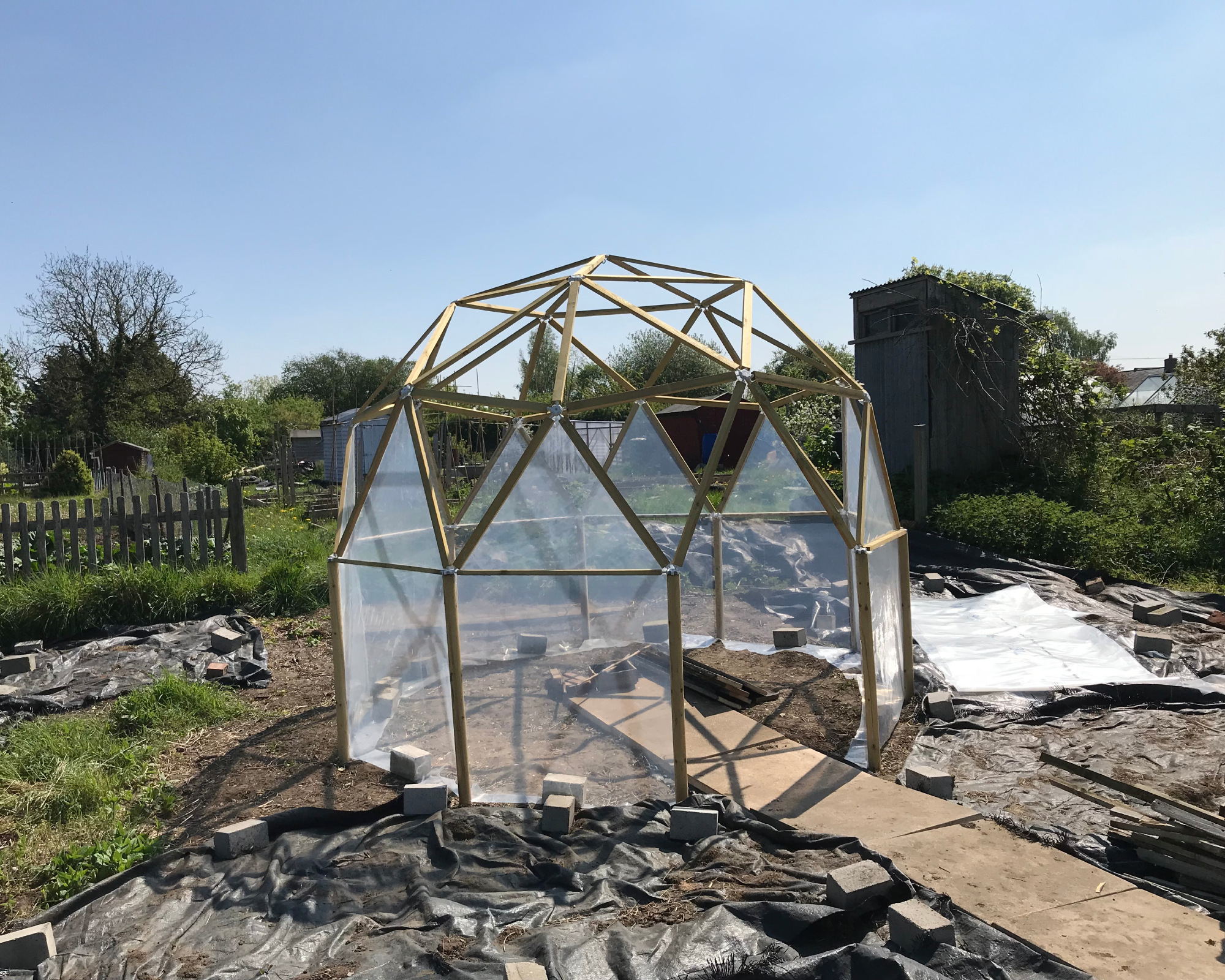 DIY greenhouse geodesic kit with sheeting attached