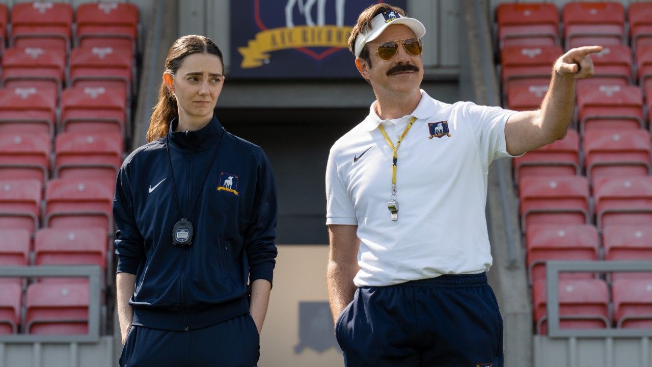 From left to right: Tanya Reynolds and Jason Sudeikis on the pitch in Ted Lasso. 