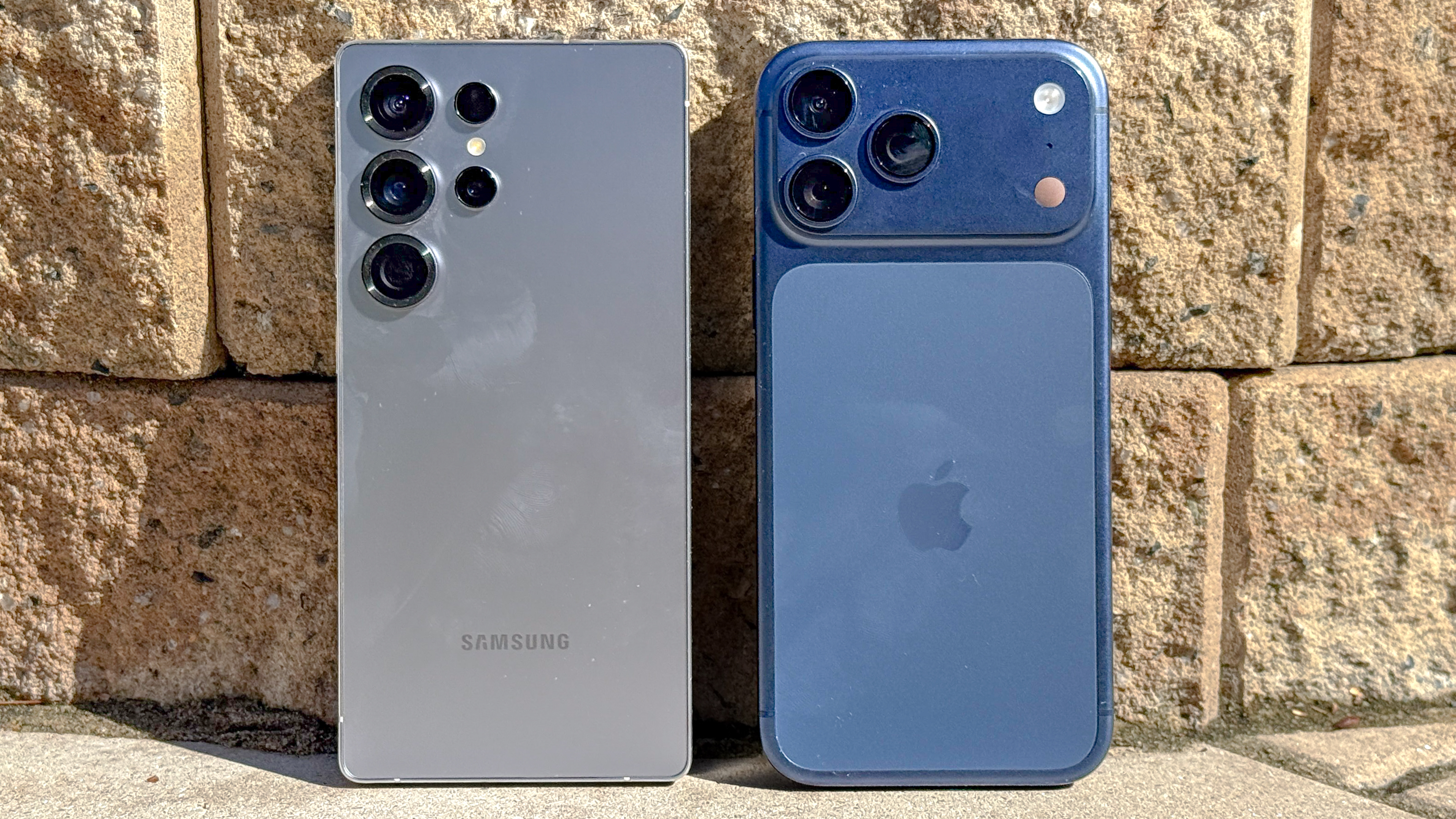 iPhone 17 Pro Max and Galaxy S25 Ultra held in the hand.