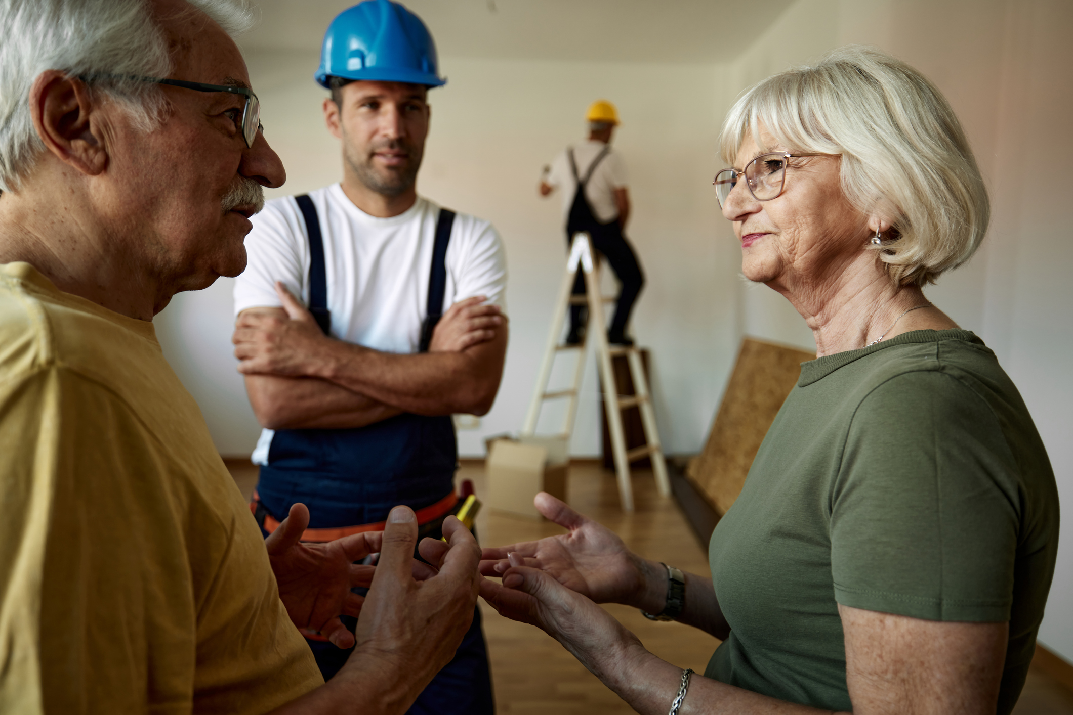 Couple discussing home repairs with their contractor