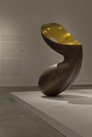 Freestanding wooden sculpture with indented, gold top