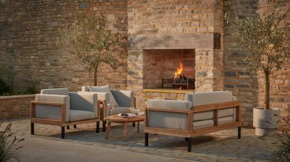 cox &amp; cox furniture in paved courtyard with fireplace