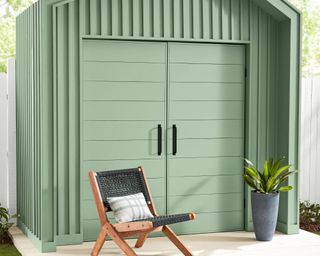 valspar Green Trellis on a shed with a wooden chair placed in front of it